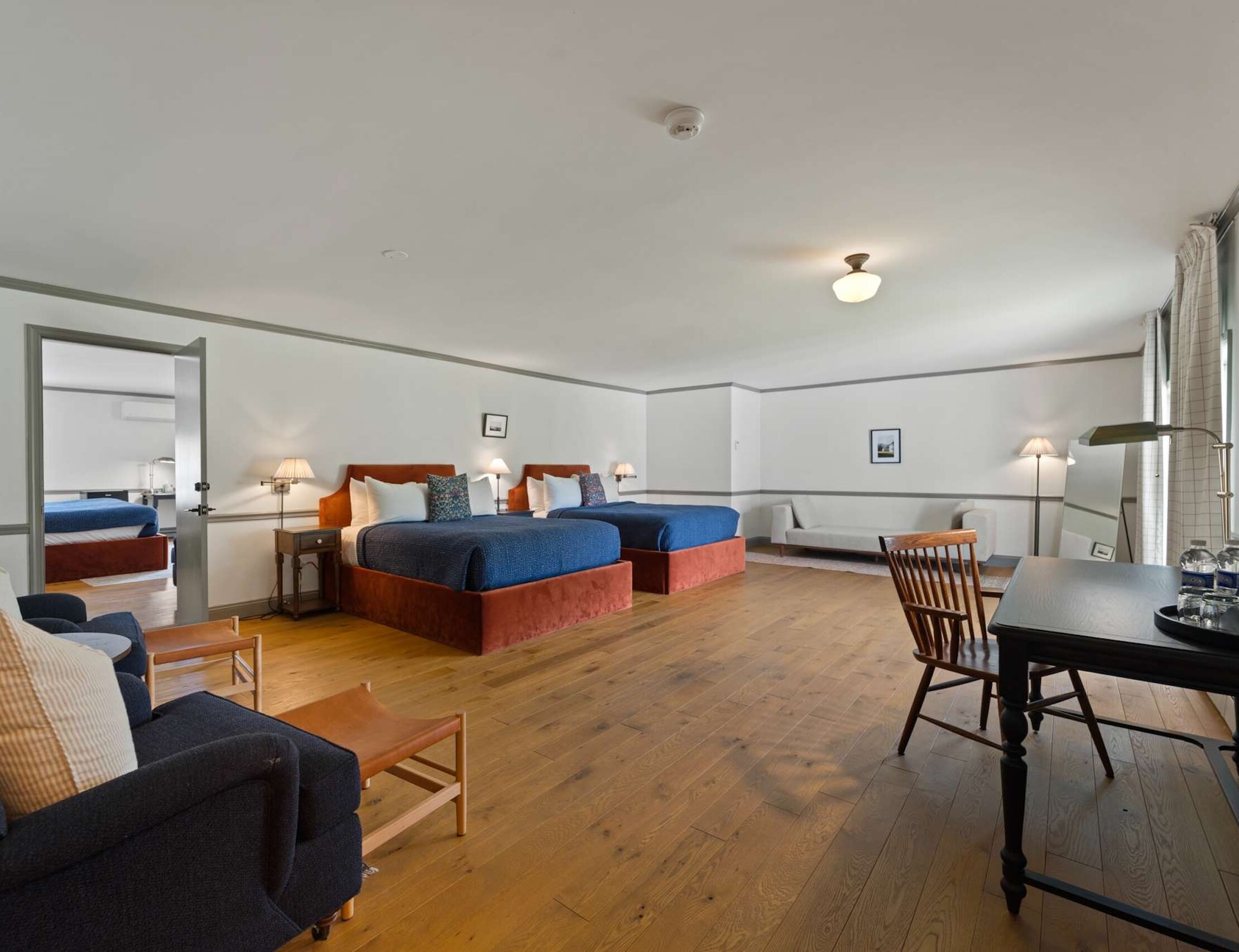 Beds and seating area with desk of the Evergreen Suite